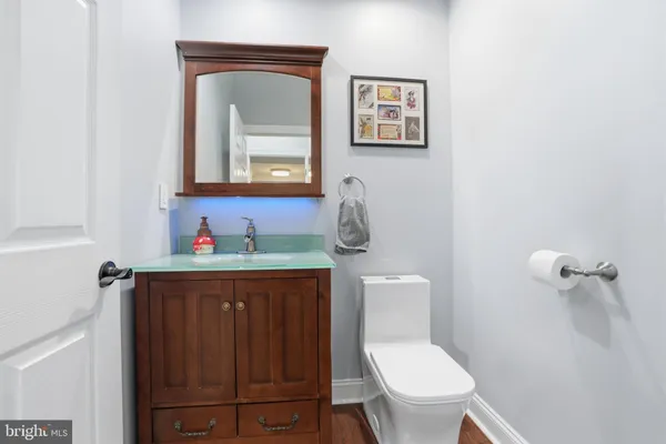 a bathroom with a toilet a sink and mirror