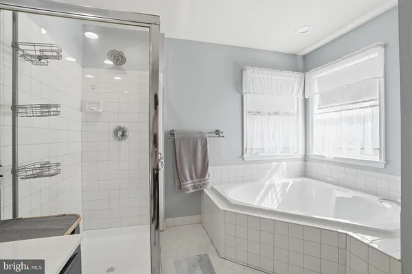 a bathroom with a bathtub and shower
