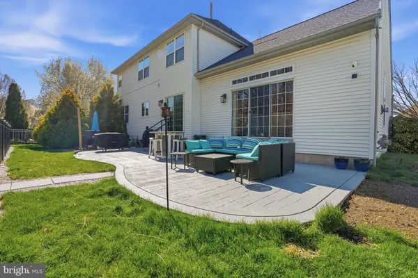 a view of a house with backyard porch and sitting area