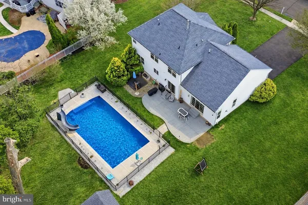 an aerial view of house with backyard space and pool