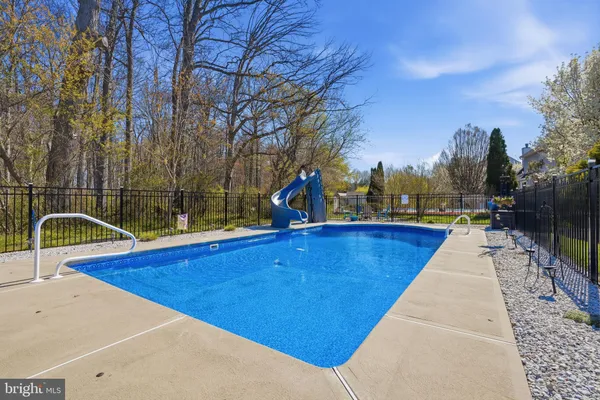 a view of swimming pool with a lounge chair