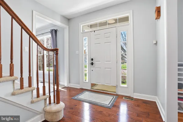 a view of an entryway with wooden floor and door