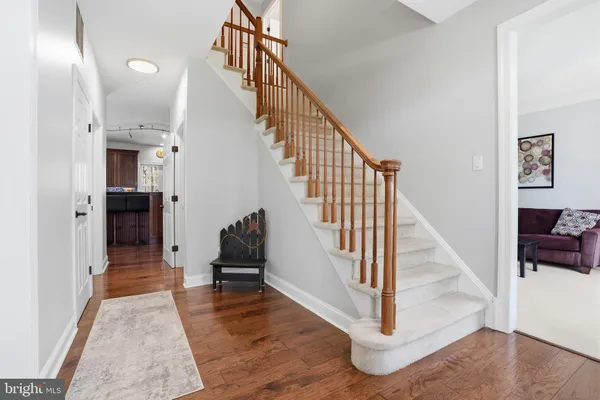 a view of entryway and hall with wooden floor