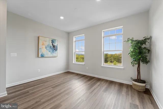 a view of room with window and wooden floor