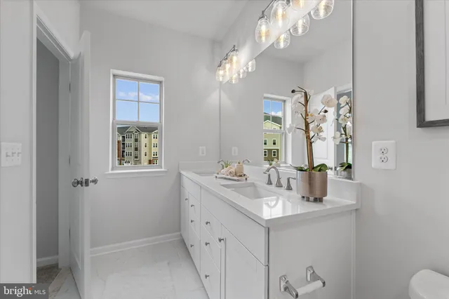 a bathroom with a sink vanity and a mirror
