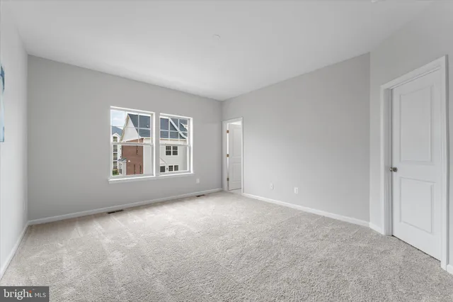 a view of an empty room with windows