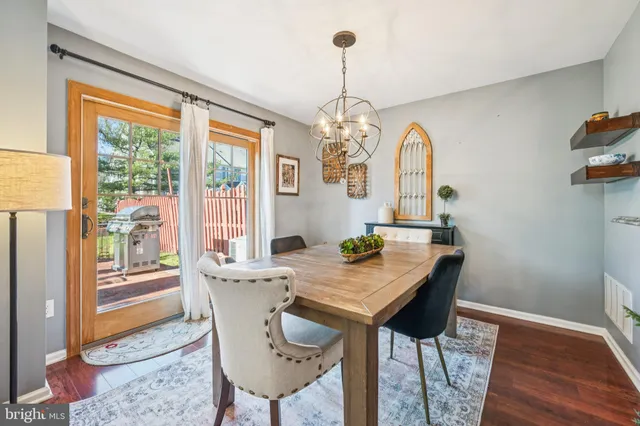 a view of a dining room with furniture wooden floor and chandelier
