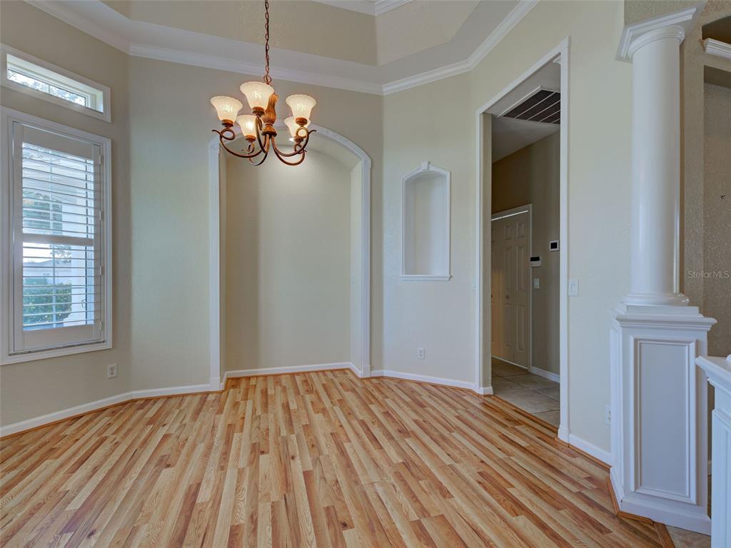 45 Tee View Road Rotonda West, FL 33947 - Photo 13 of 64 a view of empty room with window and wooden floor