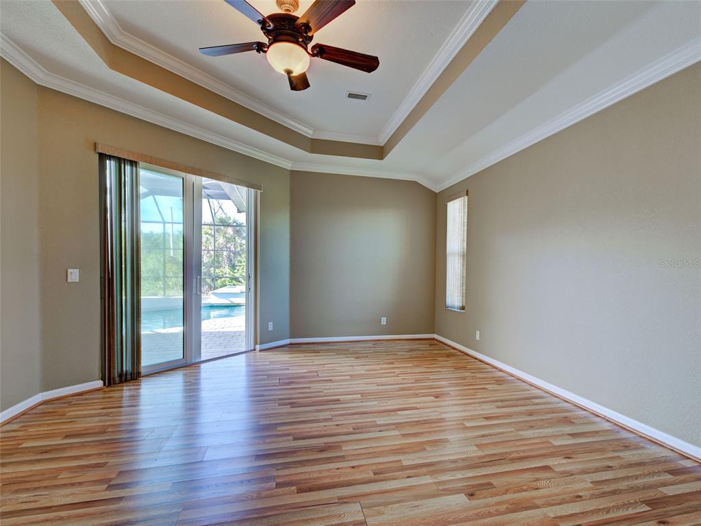 45 Tee View Road Rotonda West, FL 33947 - Photo 14 of 64 wooden floor in an empty room with a window