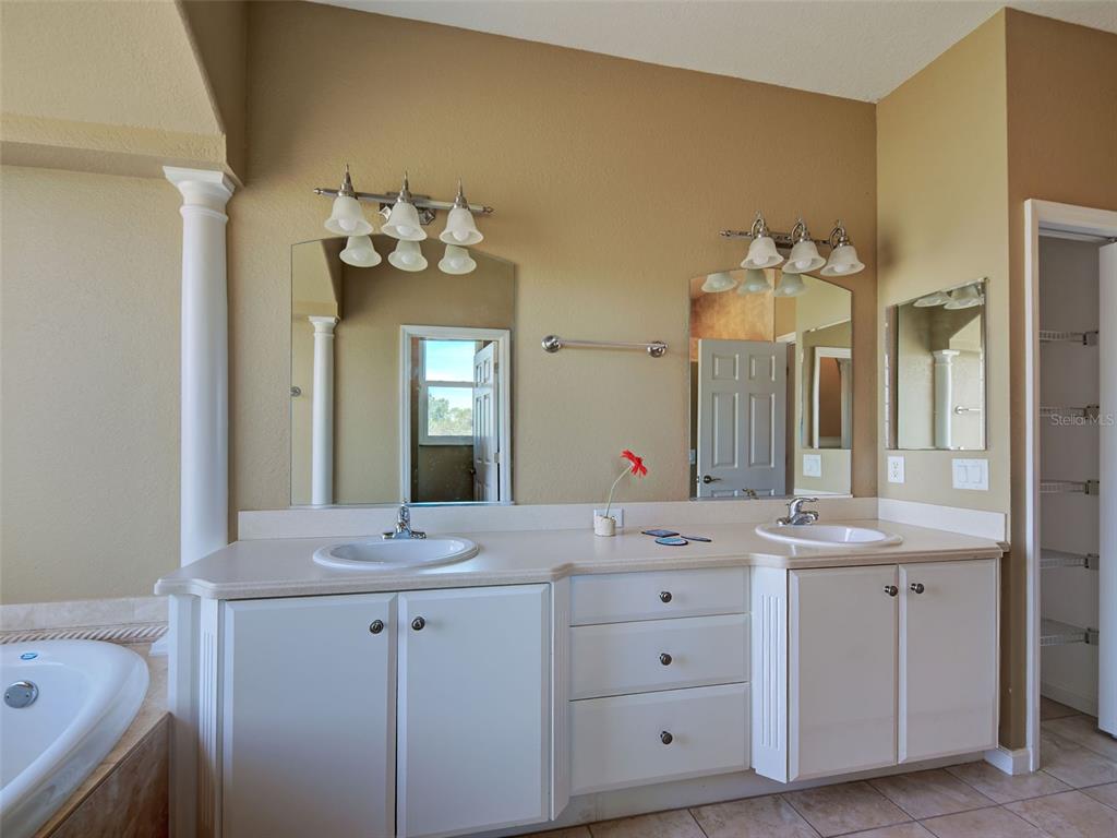 45 Tee View Road Rotonda West, FL 33947 - Photo 20 of 64 a bathroom with a sink vanity and a mirror