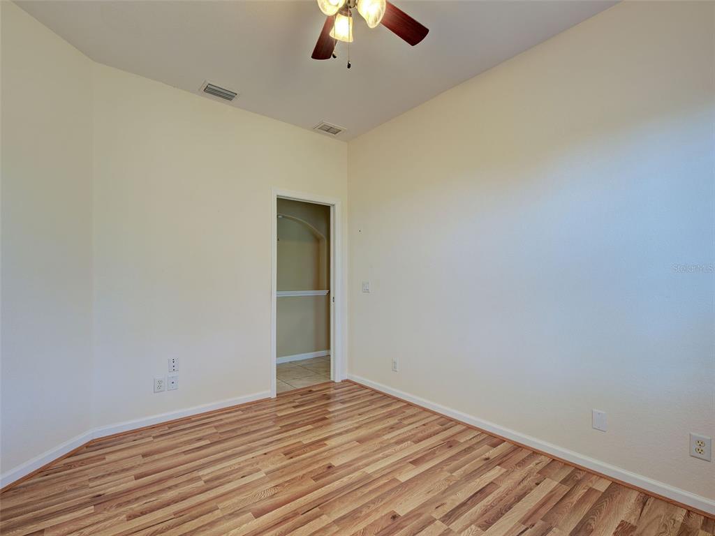 45 Tee View Road Rotonda West, FL 33947 - Photo 22 of 64 a view of empty room with wooden floor and fan
