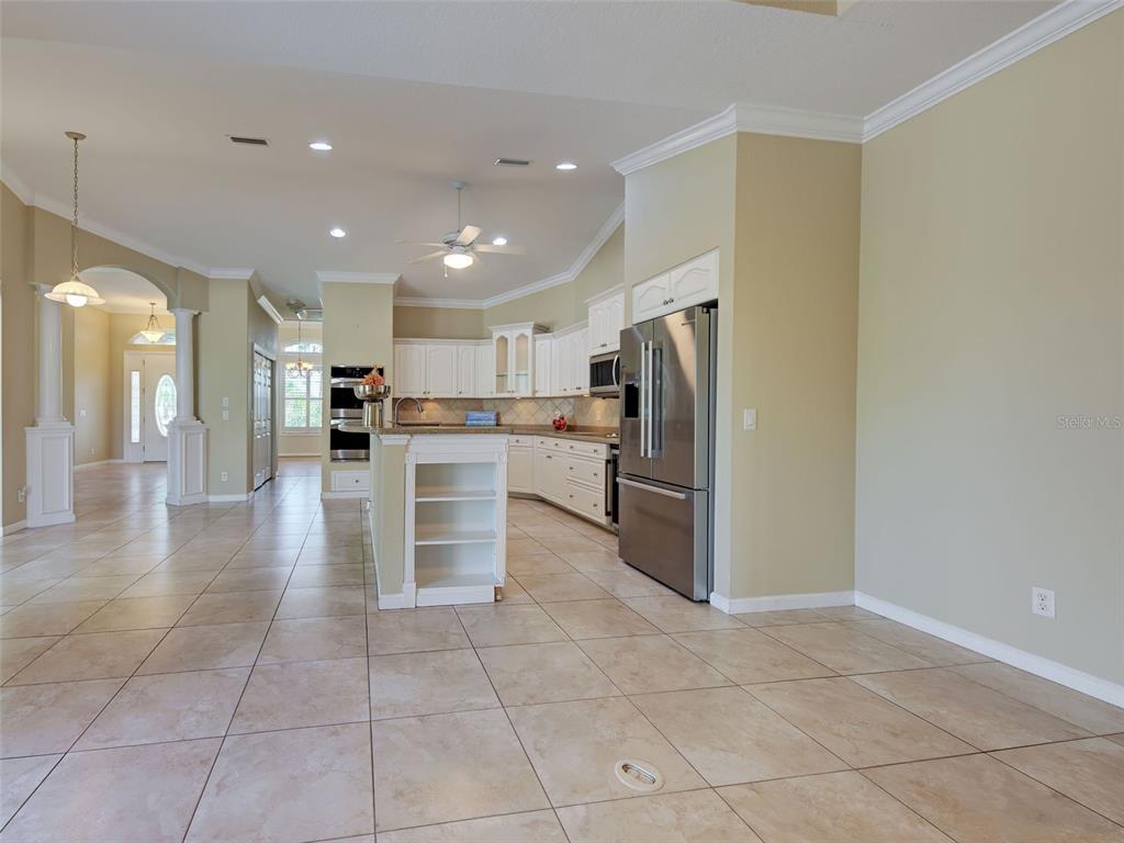 45 Tee View Road Rotonda West, FL 33947 - Photo 33 of 64 a kitchen with stainless steel appliances granite countertop a refrigerator and a stove top oven