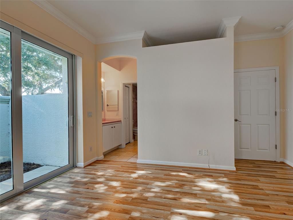 45 Tee View Road Rotonda West, FL 33947 - Photo 35 of 64 a view of an empty room with wooden floor and a window