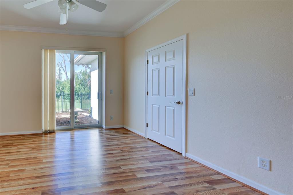 45 Tee View Road Rotonda West, FL 33947 - Photo 41 of 64 a view of an empty room with wooden floor and a window