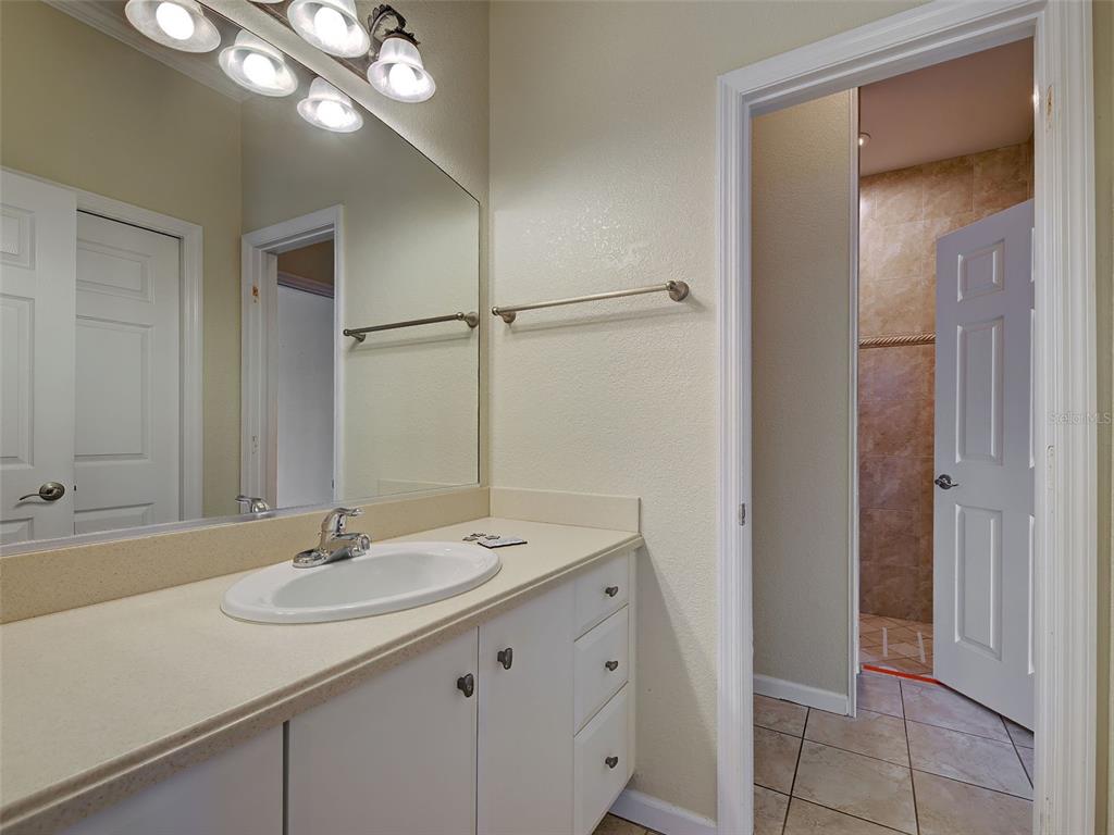 45 Tee View Road Rotonda West, FL 33947 - Photo 46 of 64 a bathroom with a sink and a mirror