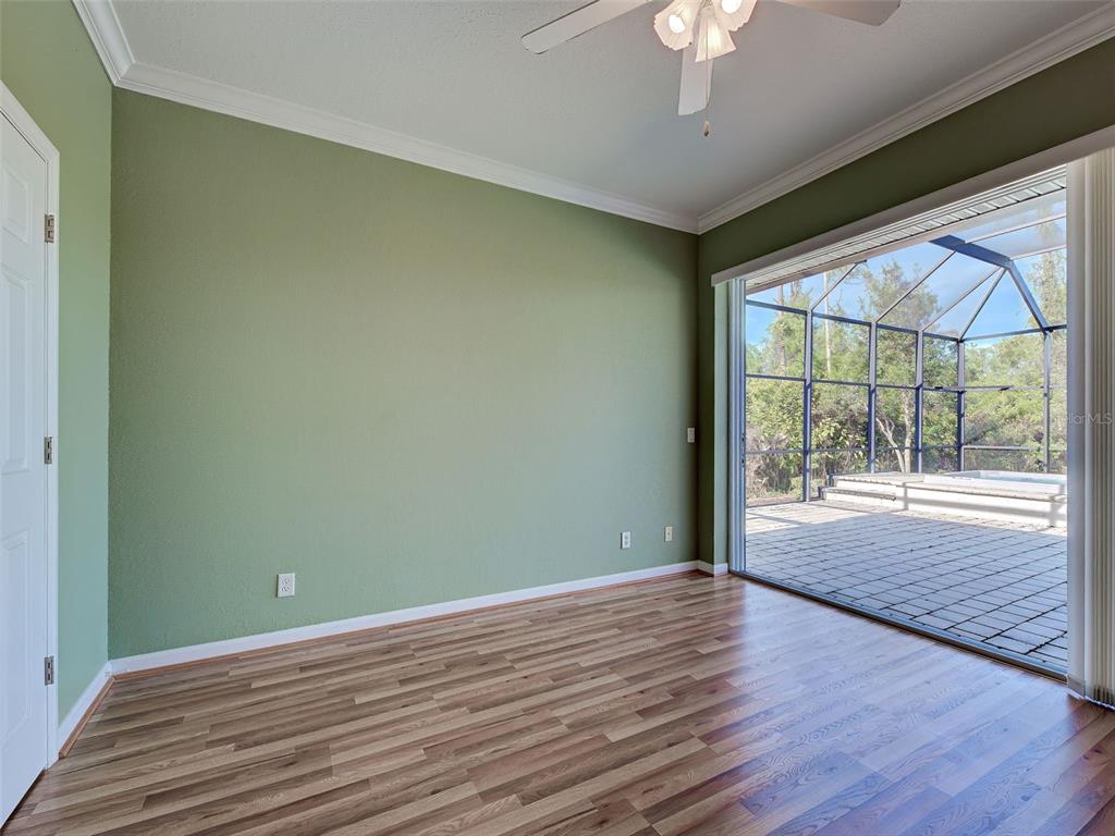 45 Tee View Road Rotonda West, FL 33947 - Photo 49 of 64 a view of an empty room with a window and wooden floor