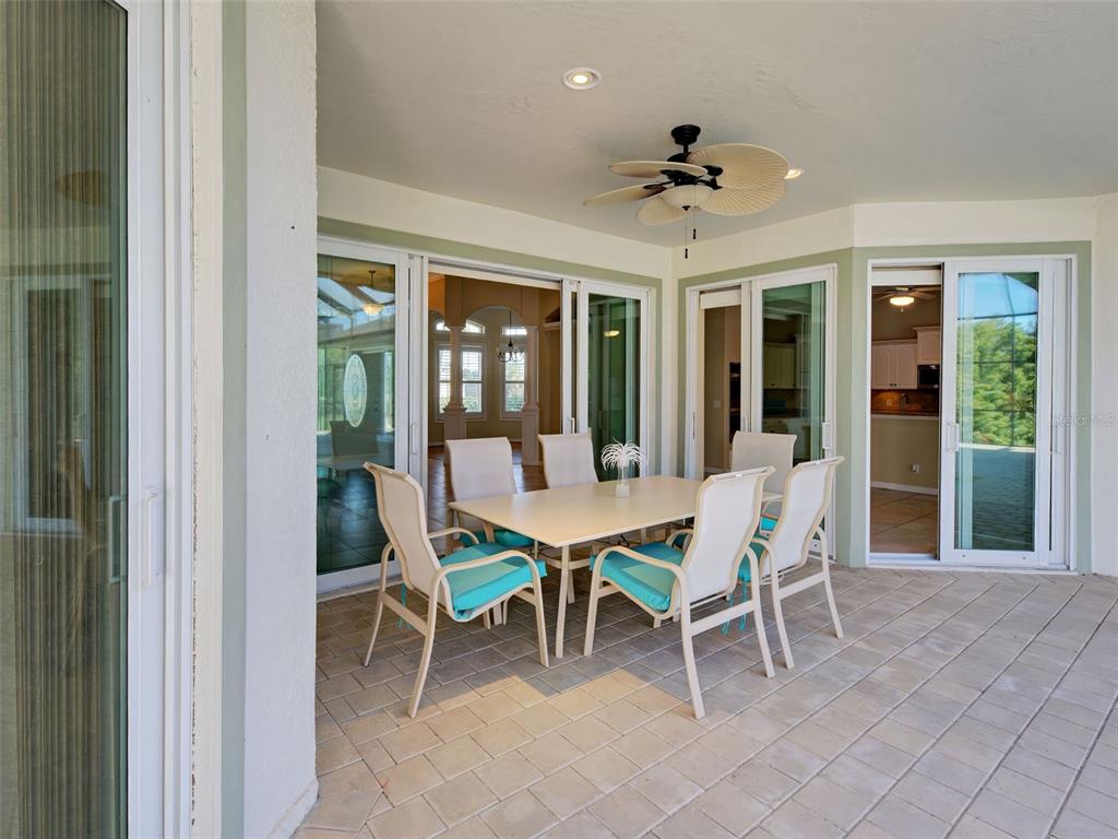 45 Tee View Road Rotonda West, FL 33947 - Photo 57 of 64 a dining room with furniture and chandelier