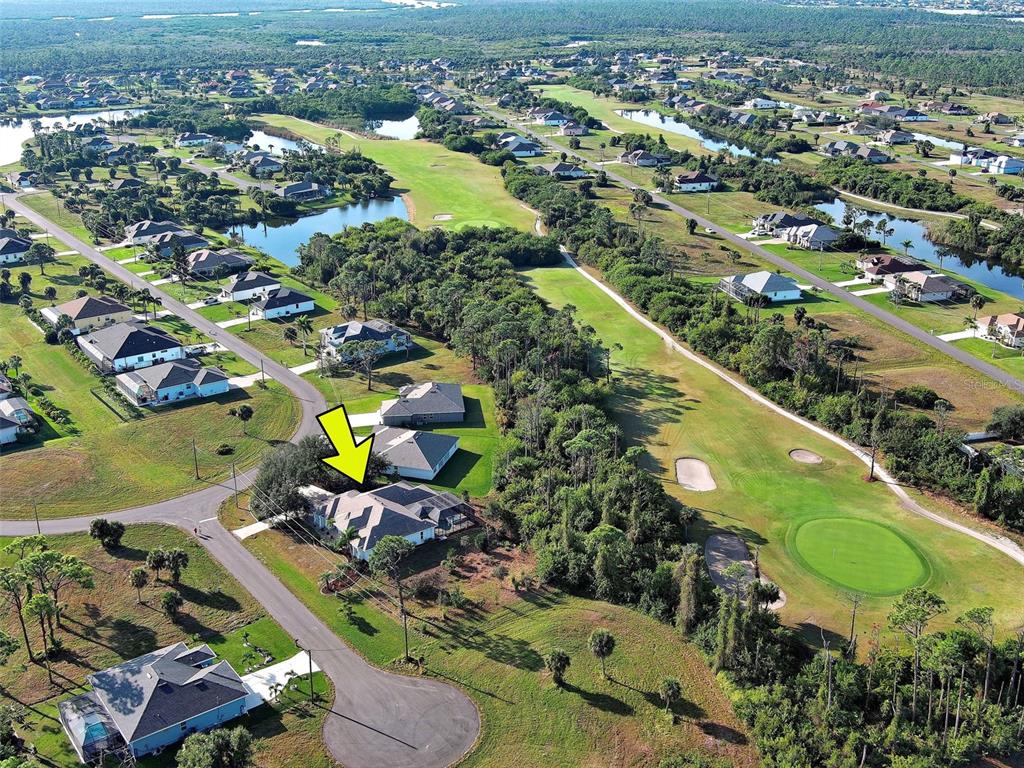 45 Tee View Road Rotonda West, FL 33947 - Photo 60 of 64 an aerial view of a swimming pool yard and mountain view in back