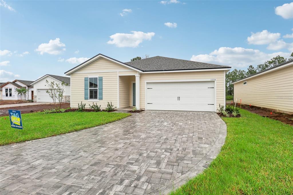 a front view of a house with a yard and garage