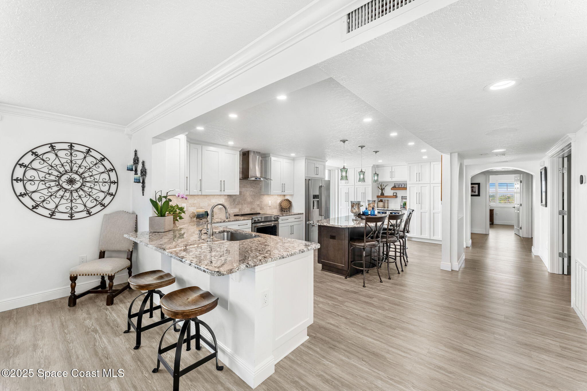 407 Florida A1A, Unit 464 Satellite Beach, FL 32937 - Photo 14 of 38 a view of a dining area with furniture and wooden floor