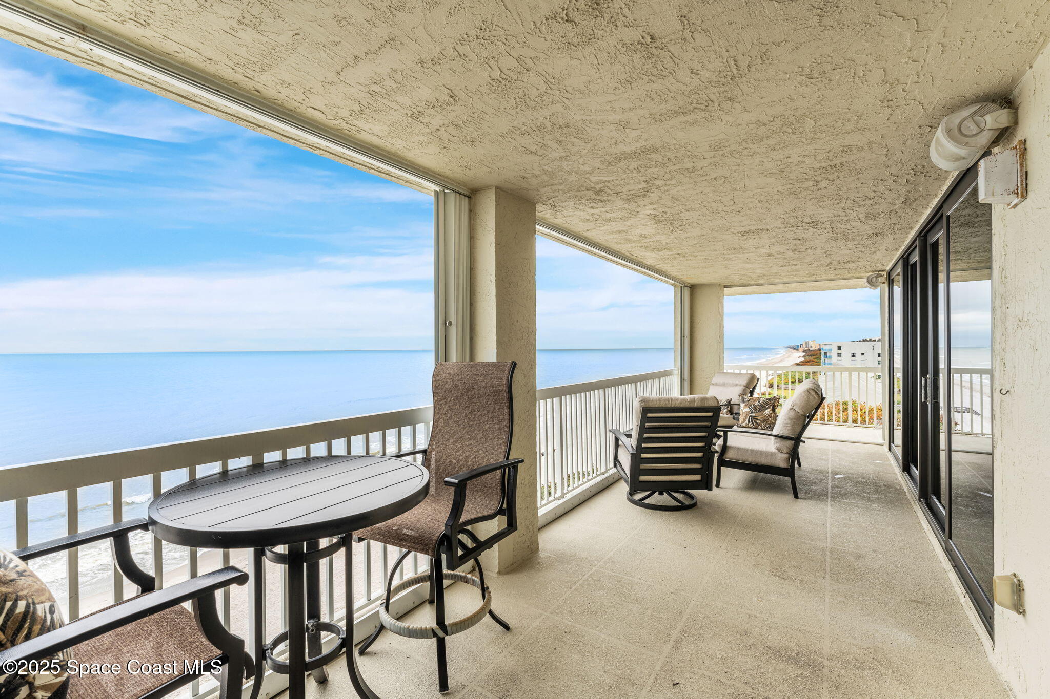 407 Florida A1A, Unit 464 Satellite Beach, FL 32937 - Photo 16 of 38 a view of a chairs and table in the balcony