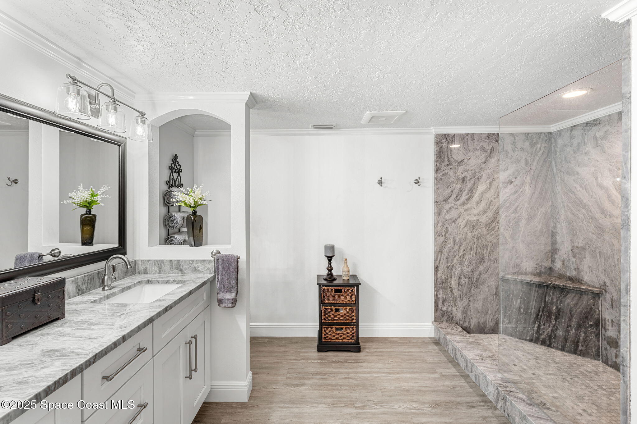 407 Florida A1A, Unit 464 Satellite Beach, FL 32937 - Photo 17 of 38 a spacious bathroom with a granite countertop sink a mirror and a shower