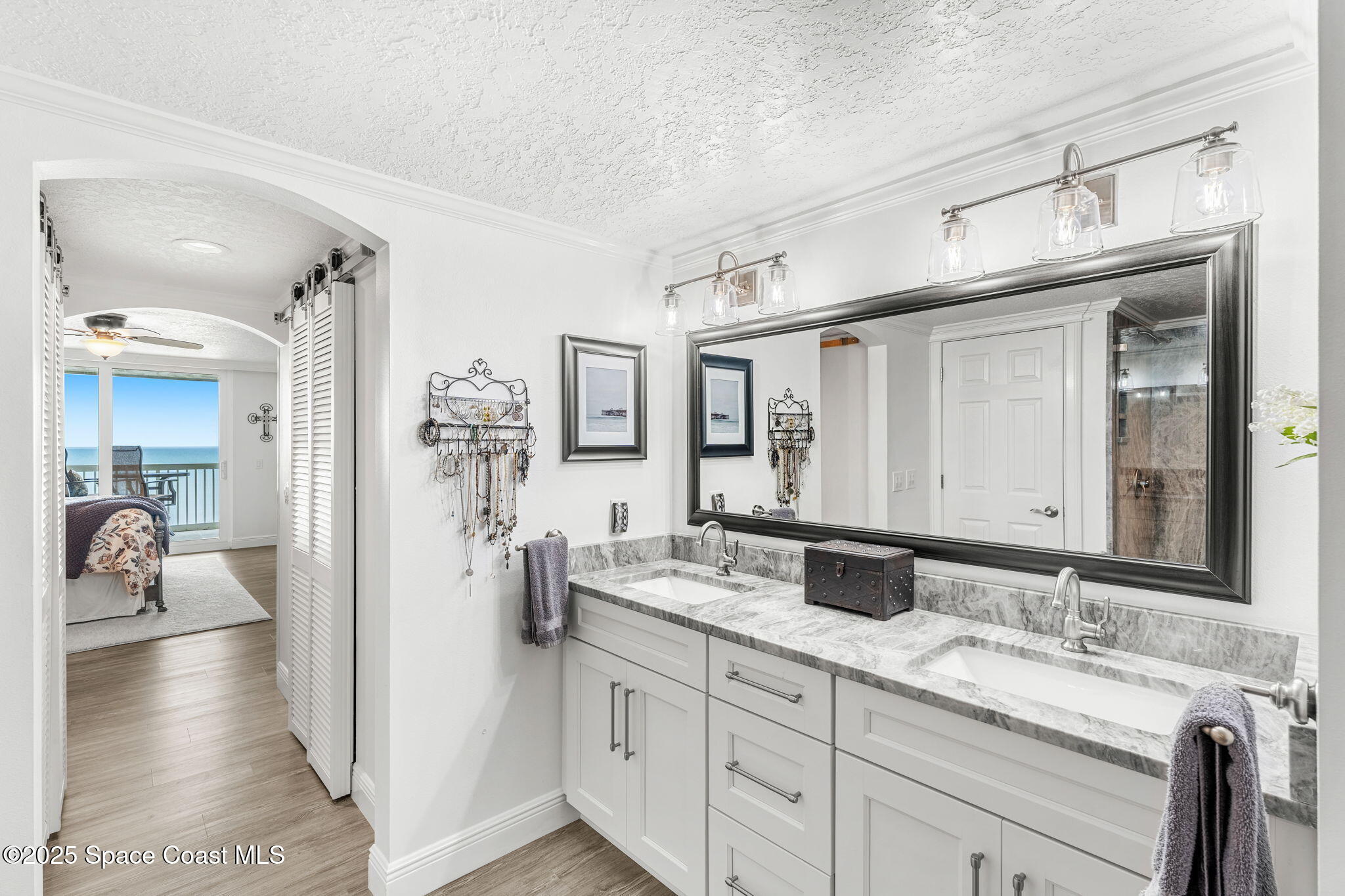 407 Florida A1A, Unit 464 Satellite Beach, FL 32937 - Photo 19 of 38 a en suite bathroom with double sink and a mirror