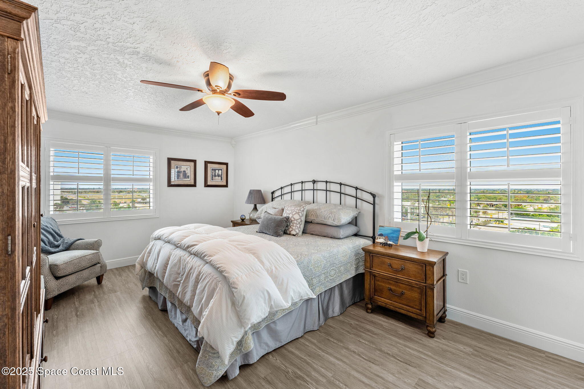 407 Florida A1A, Unit 464 Satellite Beach, FL 32937 - Photo 20 of 38 a bedroom with a bed and wooden floor