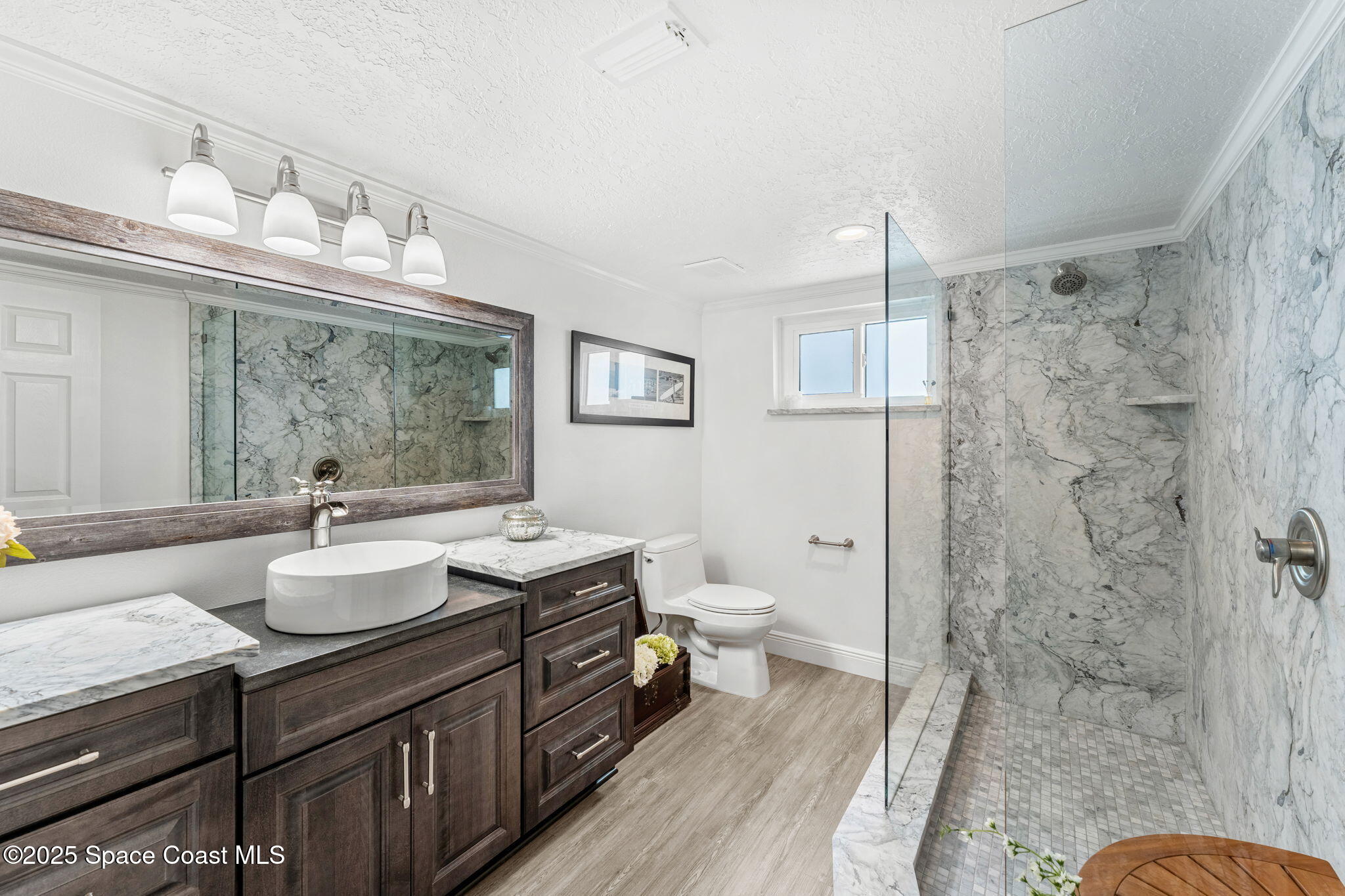 407 Florida A1A, Unit 464 Satellite Beach, FL 32937 - Photo 21 of 38 a bathroom with a sink toilet a mirror and shower