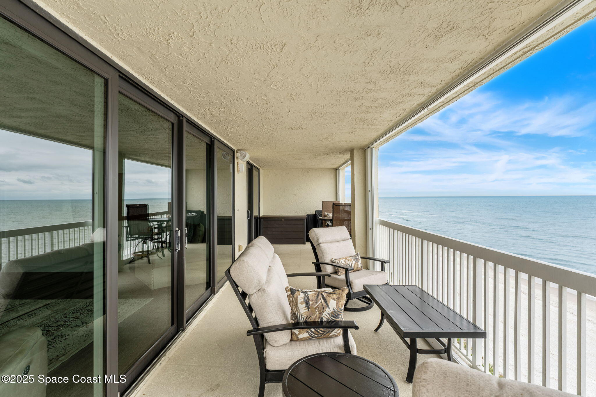 407 Florida A1A, Unit 464 Satellite Beach, FL 32937 - Photo 25 of 38 a balcony with chairs and view of outdoor space