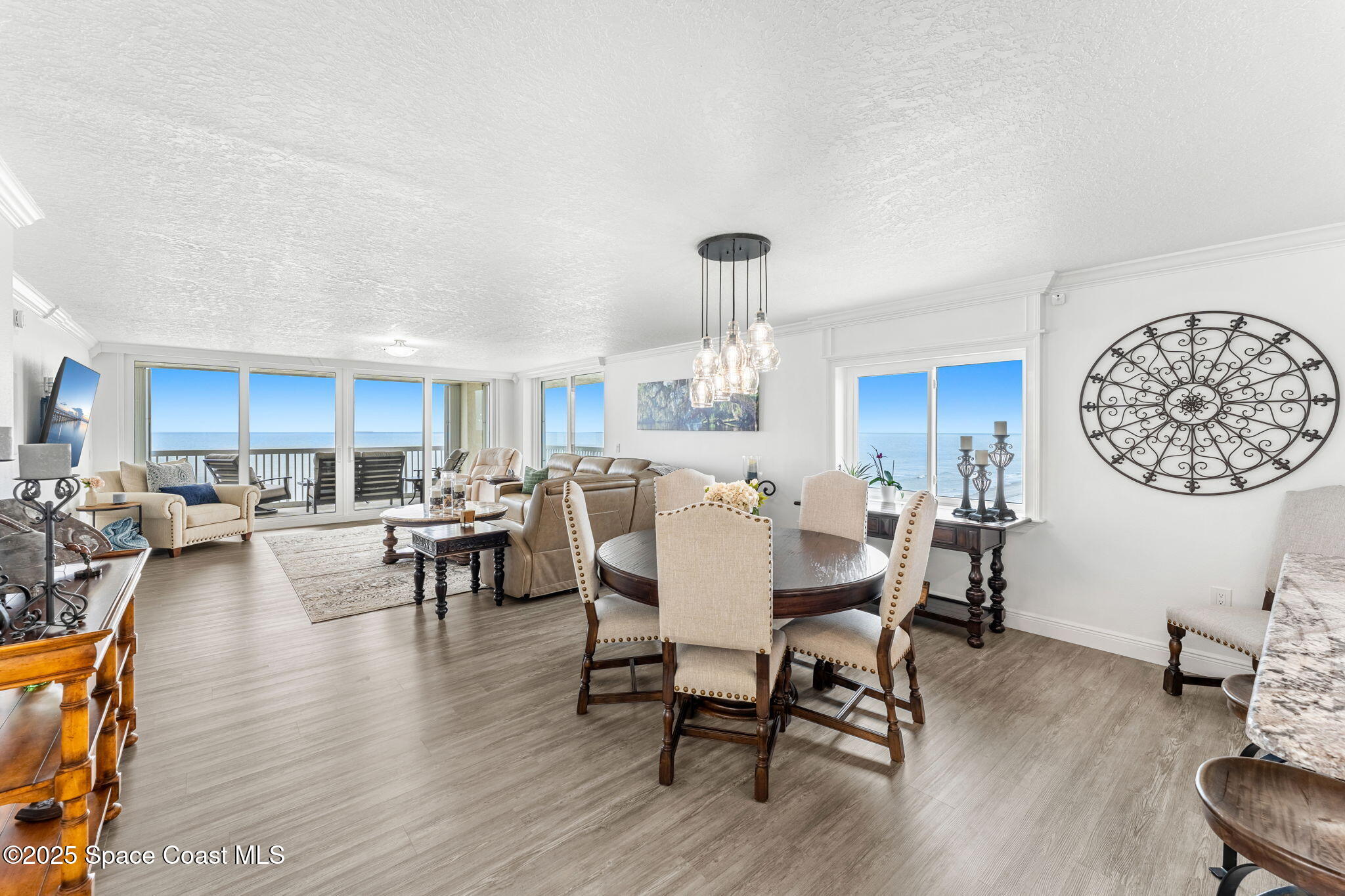 407 Florida A1A, Unit 464 Satellite Beach, FL 32937 - Photo 3 of 38 a view of a dining room with furniture window and wooden floor
