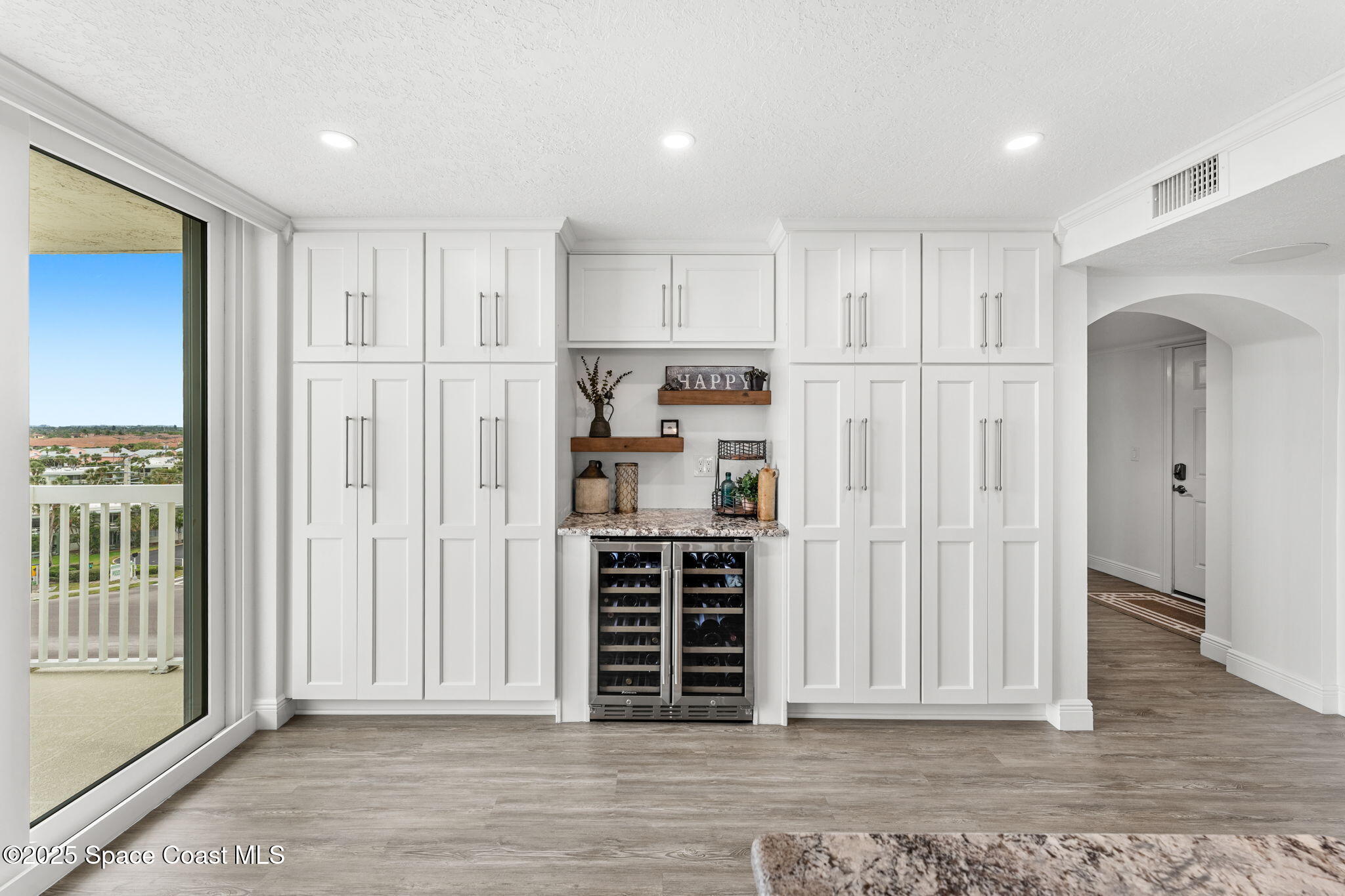 407 Florida A1A, Unit 464 Satellite Beach, FL 32937 - Photo 8 of 38 a view of kitchen with wooden floor and window