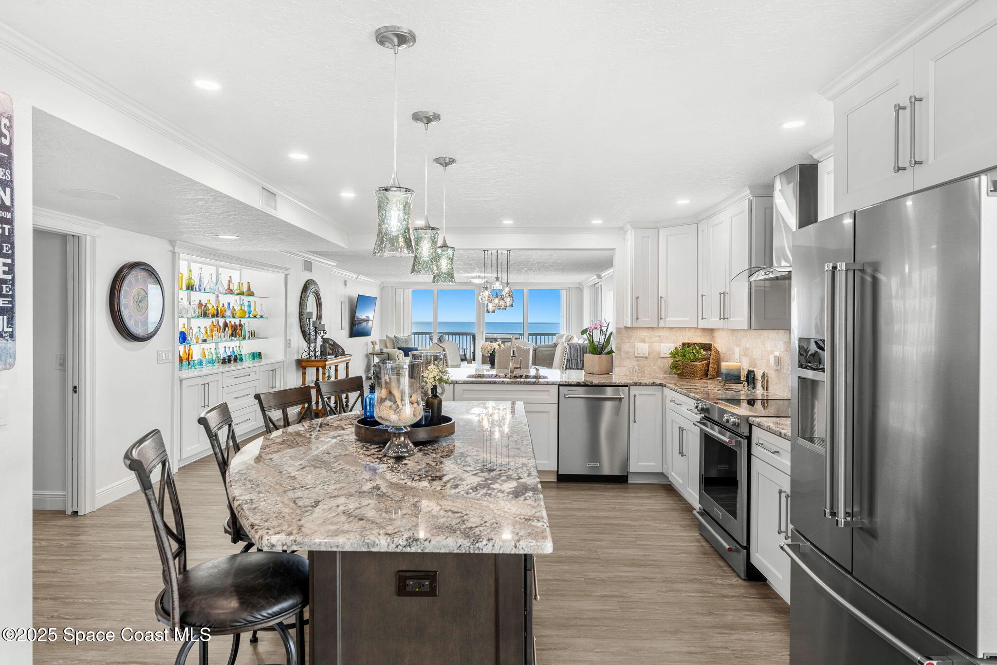407 Florida A1A, Unit 464 Satellite Beach, FL 32937 - Photo 10 of 38 a kitchen with stainless steel appliances granite countertop a dining table chairs stove refrigerator and cabinets