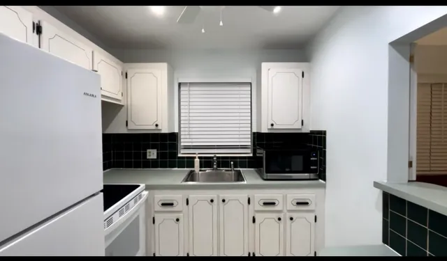 a kitchen with granite countertop a sink and a stove
