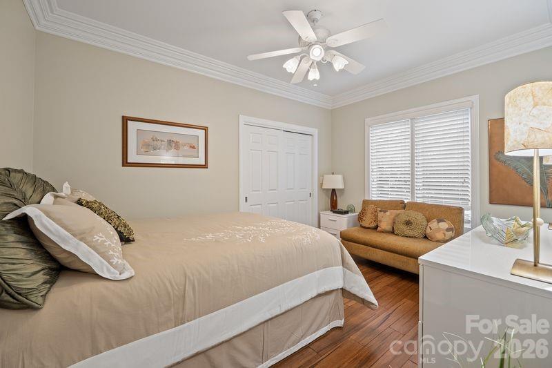 17426 Springwinds Drive, Unit 122 Cornelius, NC 28031 - Photo 15 of 36 a bedroom with a bed couches and window
