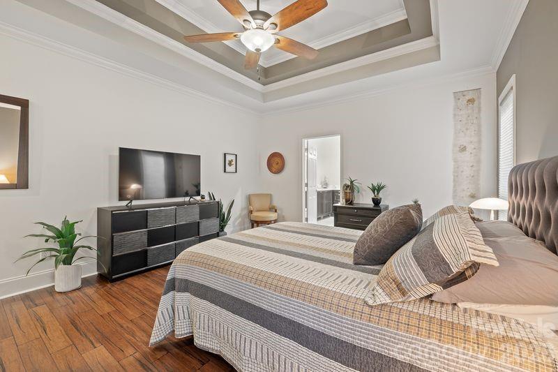 17426 Springwinds Drive, Unit 122 Cornelius, NC 28031 - Photo 19 of 36 a bedroom with a bed and a flat screen tv