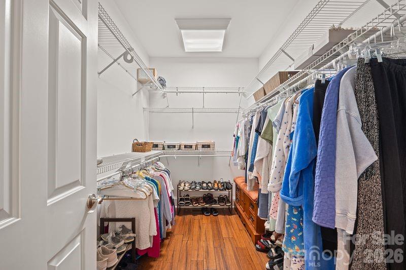 17426 Springwinds Drive, Unit 122 Cornelius, NC 28031 - Photo 20 of 36 a view of walk in closet with clothes and shoes