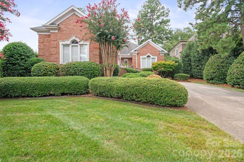 17426 Springwinds Drive, Unit 122 Cornelius, NC 28031 - Photo 2 of 36 a front view of a house with a yard and garage