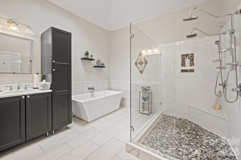 17426 Springwinds Drive, Unit 122 Cornelius, NC 28031 - Photo 21 of 36 a bathroom with a tub sink and shower