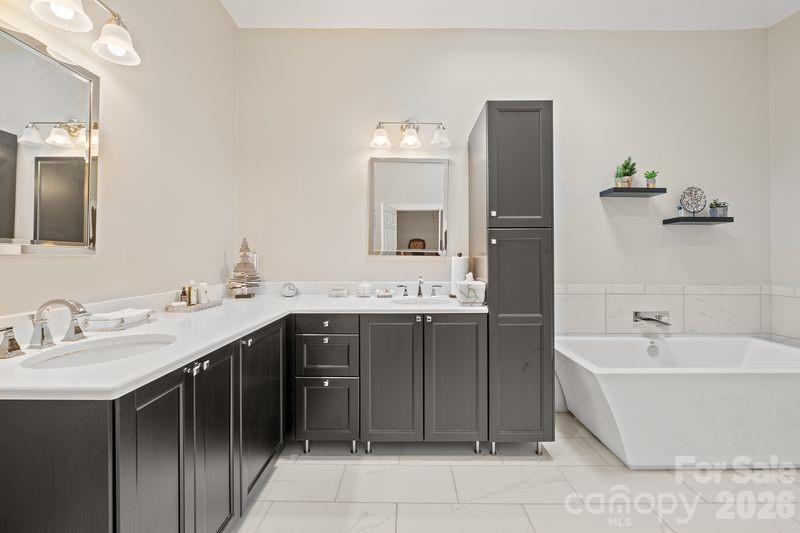 17426 Springwinds Drive, Unit 122 Cornelius, NC 28031 - Photo 22 of 36 a spacious bathroom with a bathtub double sink and mirror