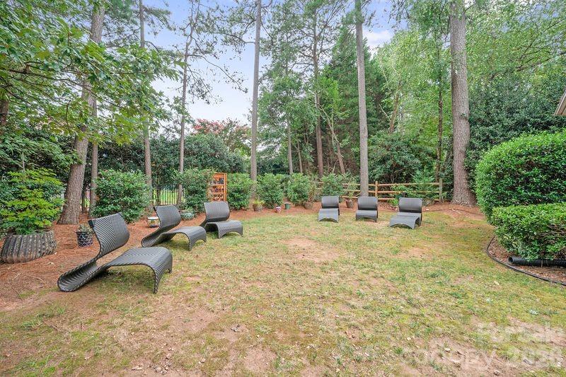 17426 Springwinds Drive, Unit 122 Cornelius, NC 28031 - Photo 28 of 36 a backyard of a house with fountain table and chairs