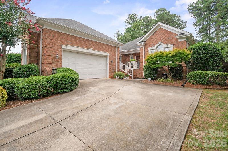 17426 Springwinds Drive, Unit 122 Cornelius, NC 28031 - Photo 3 of 36 a front view of a house with a yard and garage
