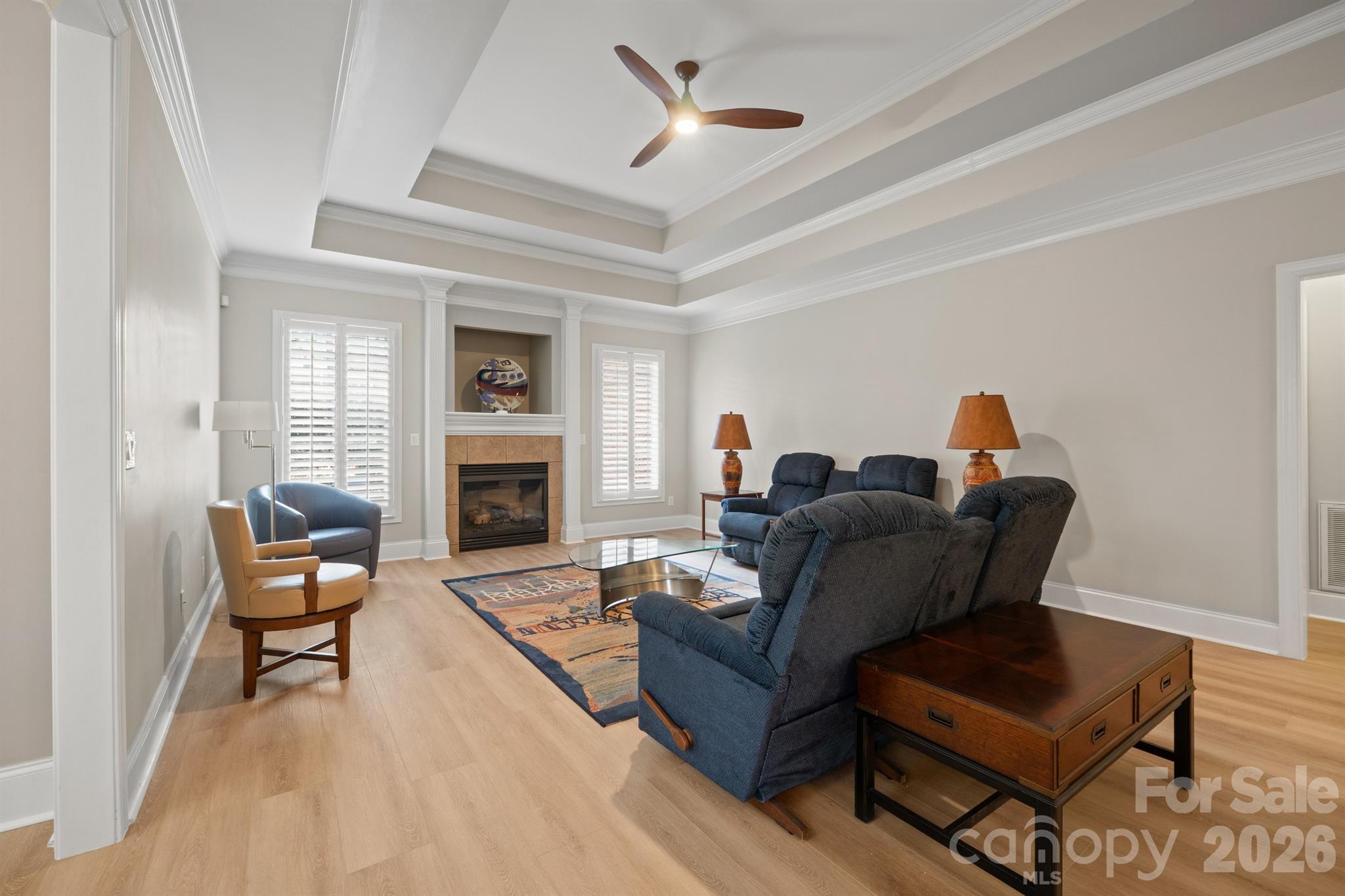 17426 Springwinds Drive, Unit 122 Cornelius, NC 28031 - Photo 32 of 36 a living room with furniture and a fireplace