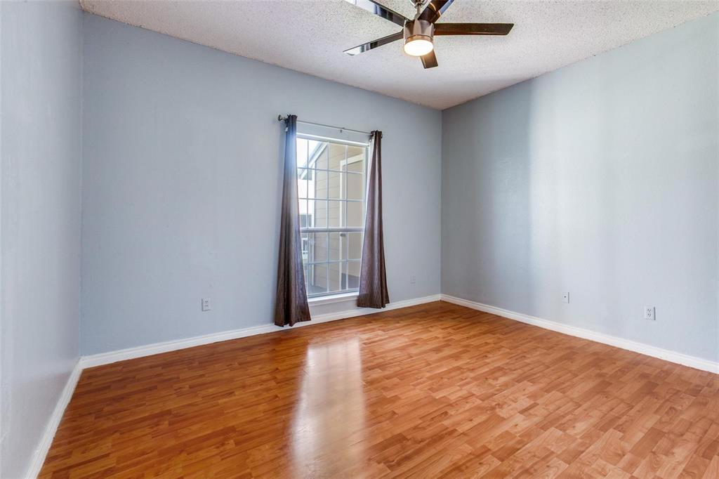 8600 Coppertowne Lane, Unit 1507 Dallas, TX 75243 - Photo 13 of 20 an empty room with wooden floor and windows
