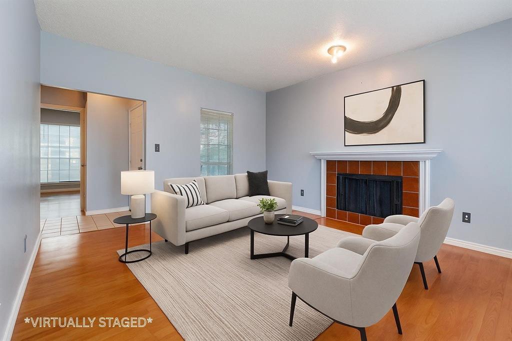 8600 Coppertowne Lane, Unit 1507 Dallas, TX 75243 - Photo 4 of 20 a living room with furniture a rug a fireplace and a table