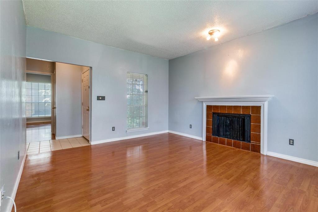 8600 Coppertowne Lane, Unit 1507 Dallas, TX 75243 - Photo 5 of 20 an empty room with wooden floor and windows