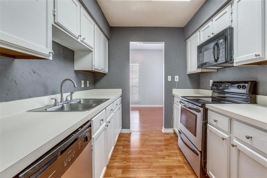 8600 Coppertowne Lane, Unit 1507 Dallas, TX 75243 - Photo 6 of 20 a kitchen with stainless steel appliances a sink stove and cabinets