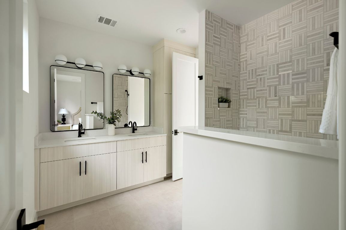 1805 Frazier Avenue Austin, TX 78704 - Photo 18 of 35 a bathroom with a double vanity sink mirror and shower