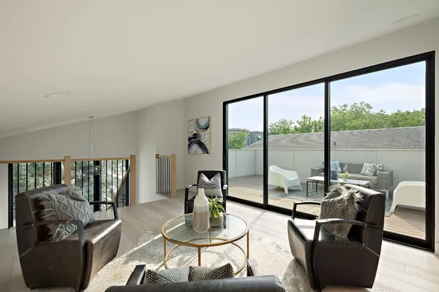 a living room with furniture and a floor to ceiling window