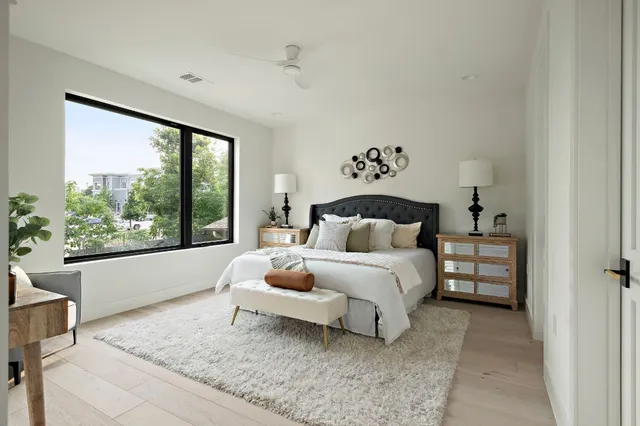 a bedroom with a large bed and a large window